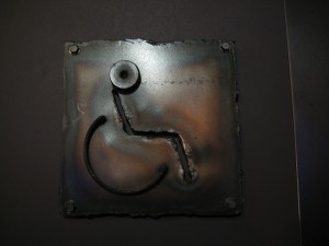 Subculture wheelchair accessible bathroom sign